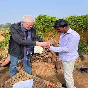 صورة لويم فان براكل (يسارًا) المدير الطبي لمنظمة «القضاء على البرص» No Leprosy Remains وهو يعطي دواءً لمريض للحد من انتشار البرص في الهند.